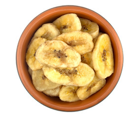 Banana chips in bowl on white background