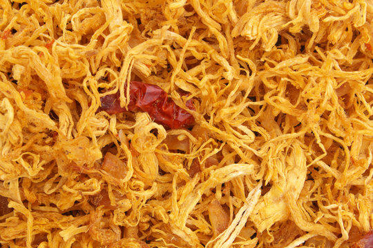 Dried spicy shredded chicken meat background