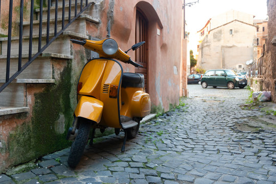orange scooter in typical Italian street
