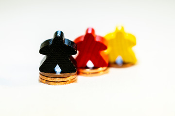 Coins pile with meeple on top, success concept