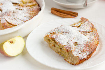 traditional homemade Apple pie with cinnamon and tea utensils on the table