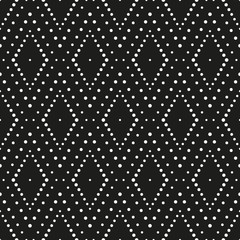 Geometric ornament of rhombuses. Pattern of white dots on a black background. Vector seamless pattern.