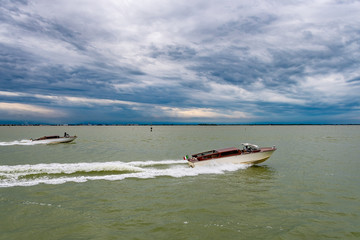 Fototapeta premium Speed boats on the sea with some dark clouds