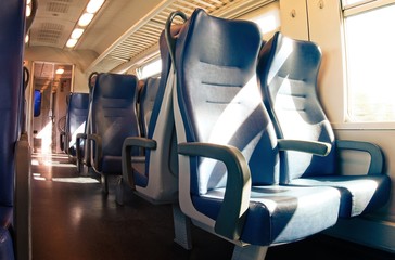 Fototapeta premium Interior of a passenger train with empty seats.