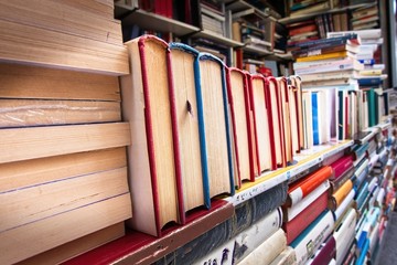 Piles of old books on a stall.