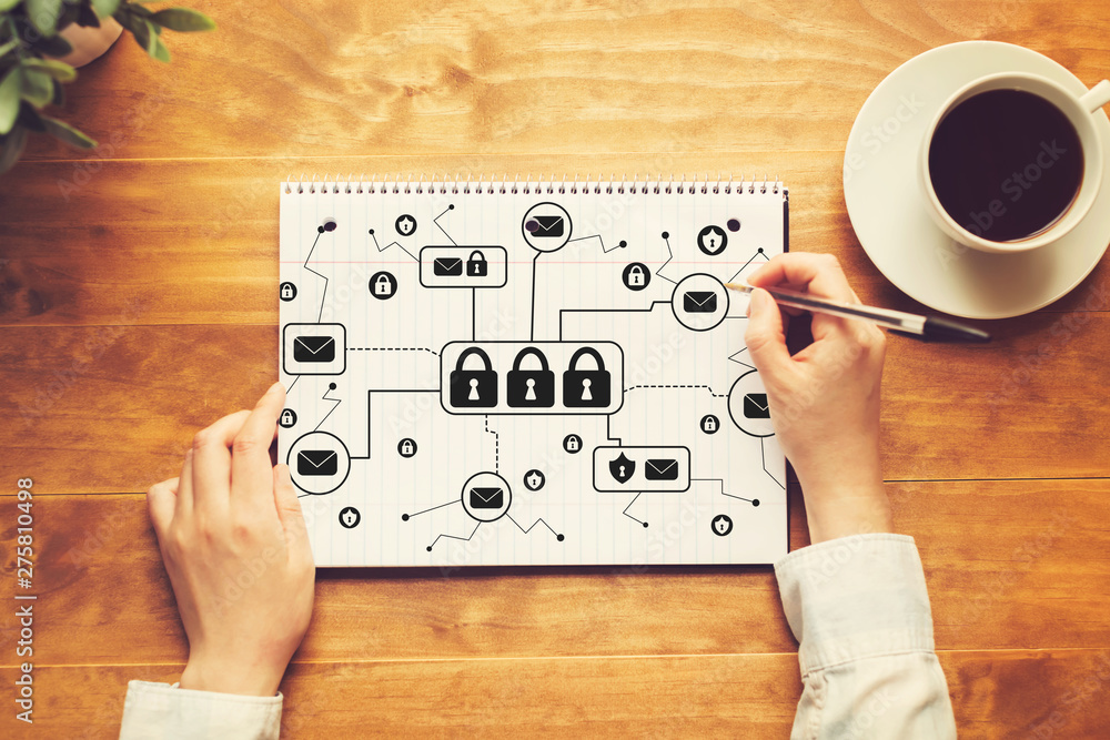Poster email security theme with a person writing in a notebook on a wooden table