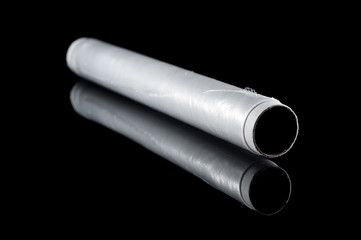 Food stretch film in a roll on a black background, isolate with reflection on the glass