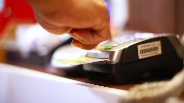 Hand put credit card In slot of credit card reader and press the button, credit card payment, buy and sell products & service, the concept of payment without cash, selective focus.