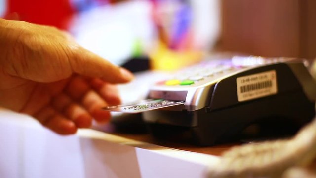 Hand put credit card In slot of credit card reader and press the button, credit card payment, buy and sell products & service, the concept of payment without cash, selective focus.