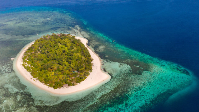 Mantigue Island, Philippines. Tropical island with white sandy beach and coral reefs. Seascape, view from above.