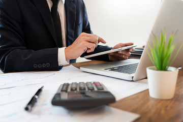 Fototapeta premium strategy analysis concept, Businessman working financial Manager Researching Process accounting calculate analyse market graph data stock information review on the table in office.