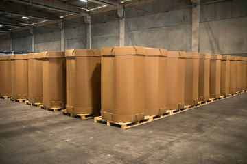 Stack of big industrial cardboard boxes. Craft Cargo Boxes stacked side by side in a factory