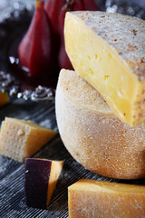 Cheese heads cut in half on wooden background. Macro photo interior.Concept of still life.Homemade...