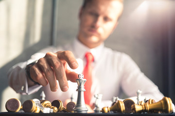 closeup business caucasian man hand with chess board strategy organization ideas concept