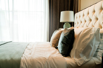 close up white beige soft pillows on bed and blanket bedroom interior design concept.bed maid...