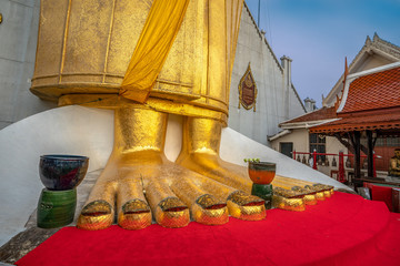 A golden tall Buddha standing at wat Intharawihan.This 32 metre high and 10 feet wide Buddha is the biggest of its kind in the world. Wat Intharawihan is on wisut Kasat road Bangkok Thailand.