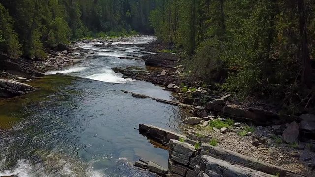 from upstream to downstream on the river, yaak falls, toward, aerial(drone) footage, v03
