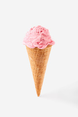 pink ice cream ball in a Waffle Cone on a white Background. Fruit ice cream in a waffle cone.