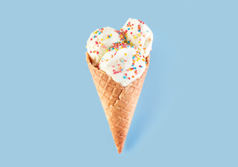 ice cream balls in a Waffle Cone on a Blue Background. Vanilla ice cream in a waffle cone.