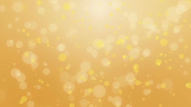 Glowing orange yellow bokeh background with floating light particles.