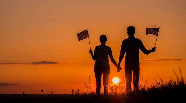 Meet the dawn together with American flags in their hands