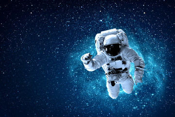 Obraz na płótnie Canvas astronaut flies over the earth in space