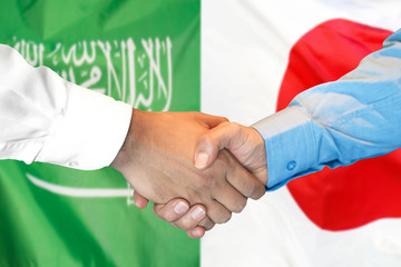 Business handshake on the background of two flags. Men handshake on the background of the Saudi Arabia and Japan flag. Support concept