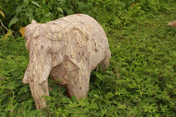 Beautiful/perfect hand carved elephant sculpture from red sand stone with natural background.