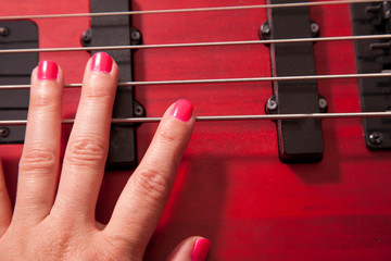 Hand on bass guitar