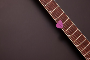 electric guitar neck and purple pick