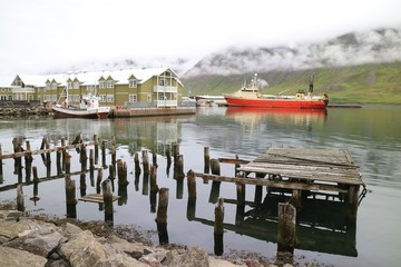Barges in a dock by the mountains in Iceland