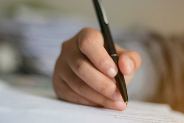 Hand holding the mouth on the document.