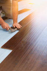 Man Installing New Laminate Wood Flooring