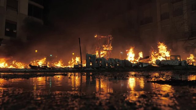 La Crema on Fallas celebration. Night view of fire ruined the festival composition with ninots in city street