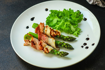 Asparagus in bacon, delicious grilled vegetables with meat wrapped. food background. top view