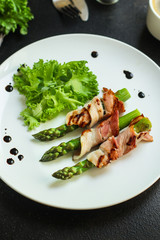 Asparagus in bacon, delicious grilled vegetables with meat wrapped. food background. top view