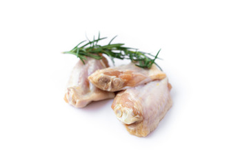Raw chicken wings with rosemary isolated on white background