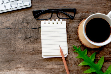 blank paper note pad , Top view on working table space 