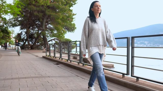 Beautiful Brunnete Traveling By Bank of River. Casually-Dressed Woman Walking by Beautiful Coast Near Water.