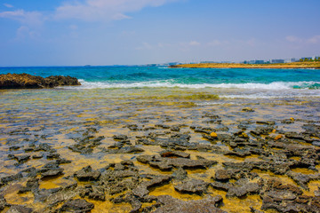  Panoramic view of Ayia Napa coast, Cyprus with blue sea and yellow-black rocks