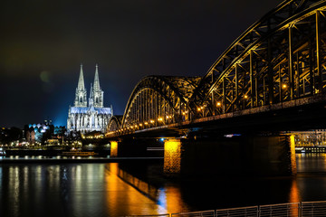 Cologne Cathedral and Hohenzollern Bridge at night in Cologne, Germany