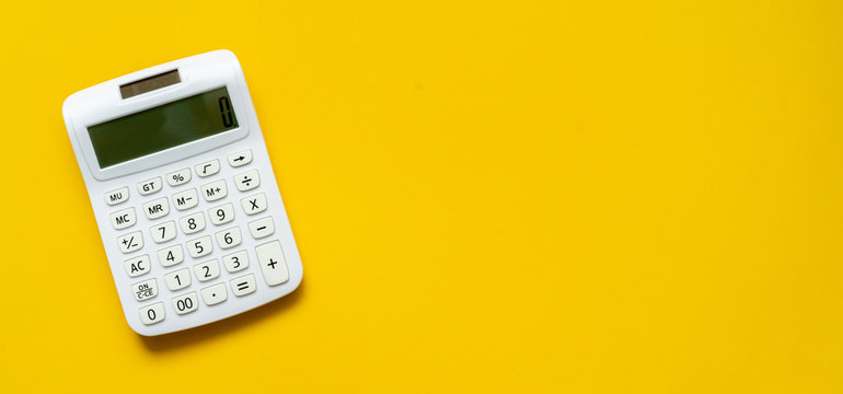 close up white calculator on yellow background for business financial concept