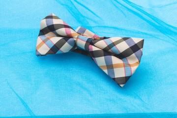 checkered tie bow on a blue background