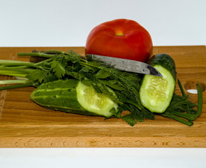 Cucumber, tomato, green onion, dill, on cutting Board