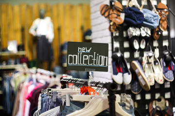 plate with the words New Collection in a clothing store, Close up, blurred background
