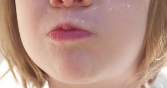 Close up, adorable little girl enjoying a healthy snack on a summer day