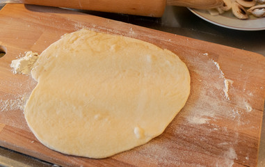 Pizzza bread laying on a wooden table