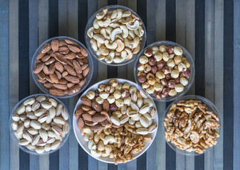 Healthy food. Nuts mix assortment on texture top view. Collection of different legumes for background image close up nuts, pistachios, almond, cashew nuts, peanut, walnut. image