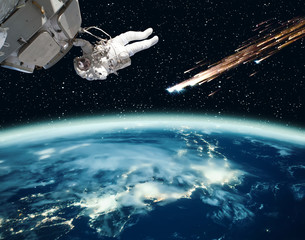 Astronaut holding for the spaceship and meteor rain. The elements of this image furnished by NASA.