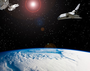 Astronaut and spaceships. Lens flare. The elements of this image furnished by NASA.